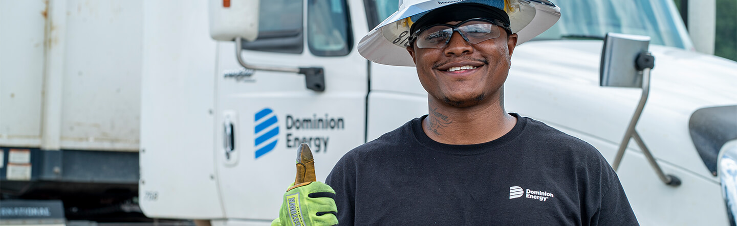 Dominion Energy Employee Standing in Front of Company Truck