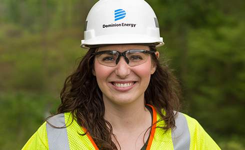 smiling female employee in protective gear