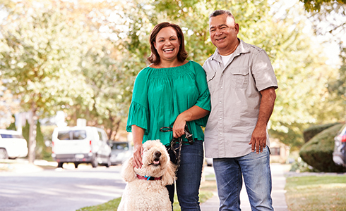 A Couple Walking Their Dog in Their Neighborhood