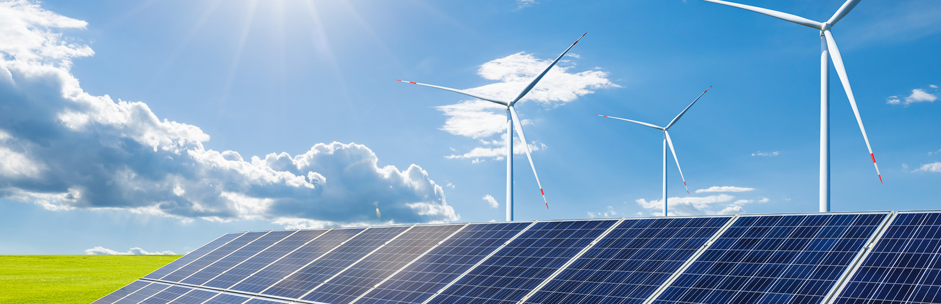 Solar panels in a field with windmills