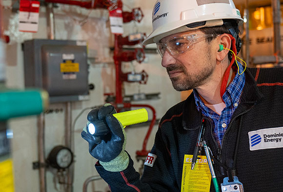 Dominion Energy employee inspecting tank