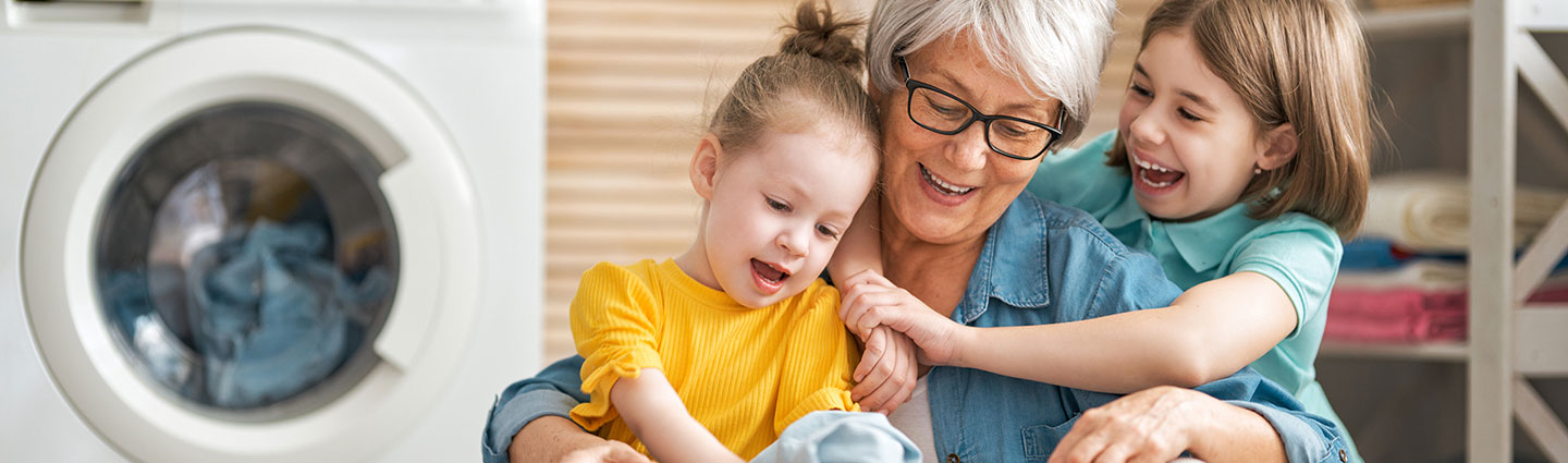 Grandmother and kids doing laundry