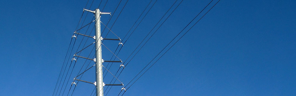 Power line poles against a blue sky
