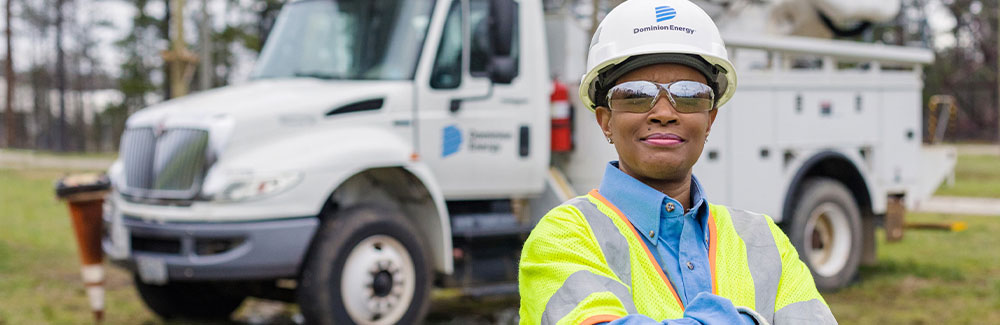 Lineworker in front of Dominion Energy truck