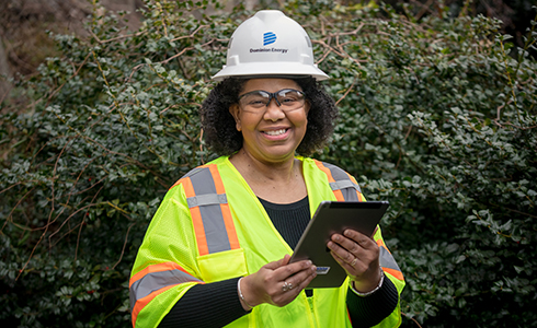 female employee in protective gear with tablet