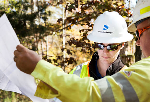 Dominion Energy Employee Reviewing Blueprints