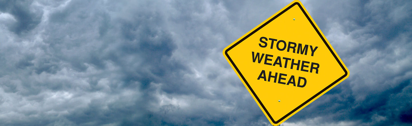 Stormy Weather Ahead sign with storm clouds behind