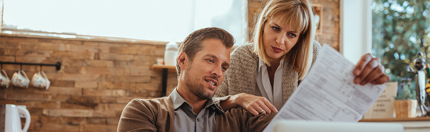 Couple Looking at Paper Billing Statement
