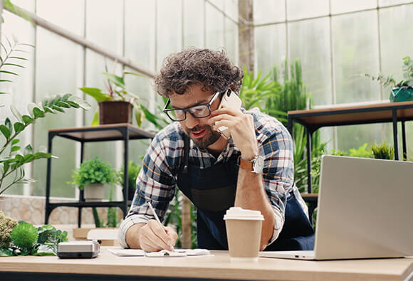 Small Business Owner on Phone and Computer