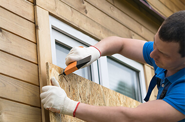 Boarding Up Windows Preparing for Storm