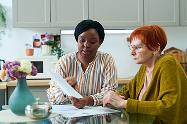 Ladies Reviewing Financial Document