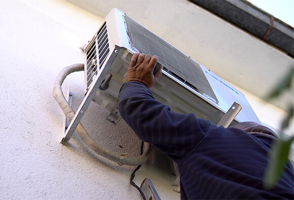 Technician Installing Air Conditioning Unit
