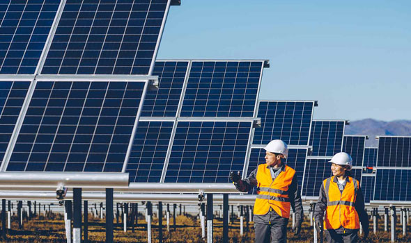 Two employees near solar panels