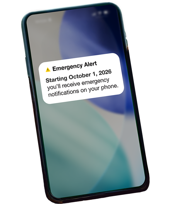 Phone screen with alert reading "Emergency Alert: Starting April 10, 2026 you'll receive emergency notifications on your phone."