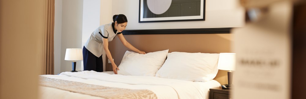 Maid cleaning a hotel room