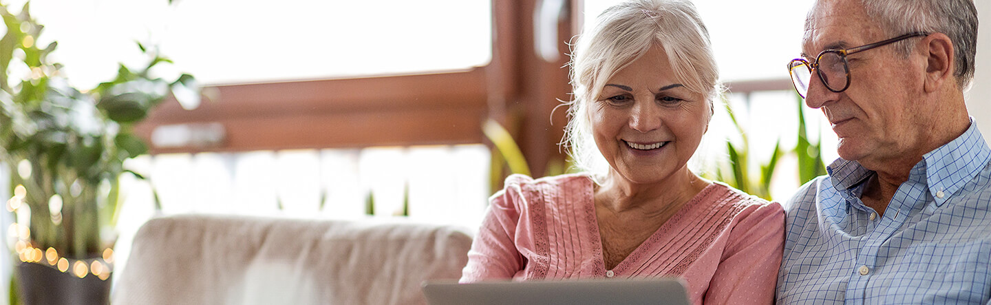 Older Couple Looking at Laptop